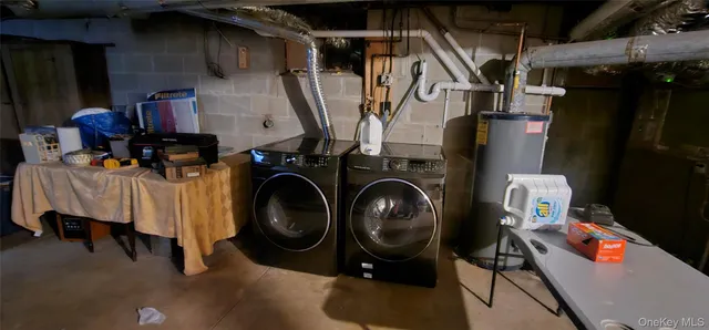 a utility room with dryer washer and other items