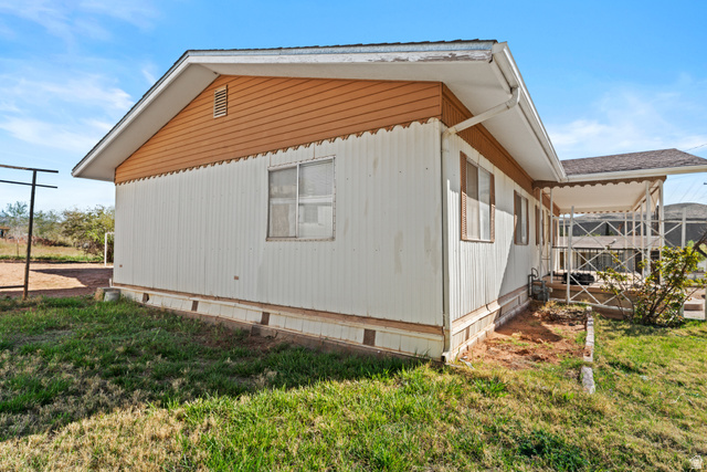 49 600 North Hurricane, UT 84737 - Photo 22 of 33 View of side of property with a lawn and crawl space