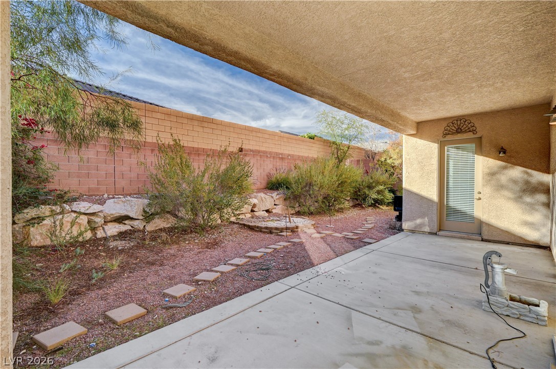 6761 Clay TABLET Street Las Vegas, NV 89149 - Photo 66 of 73 An inviting covered concrete patio leads to a private yard enclosed by masonry walls.