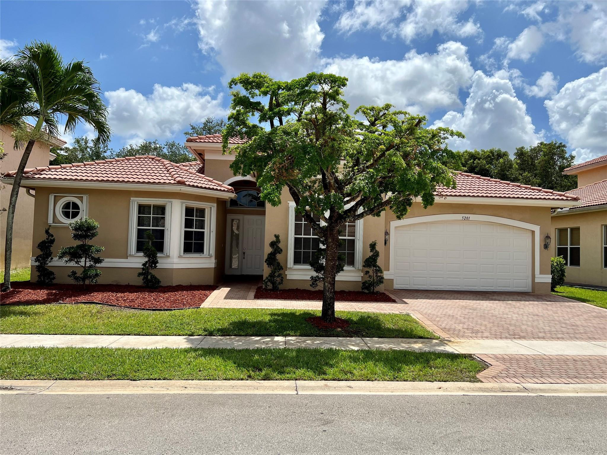 a front view of house with yard and green space