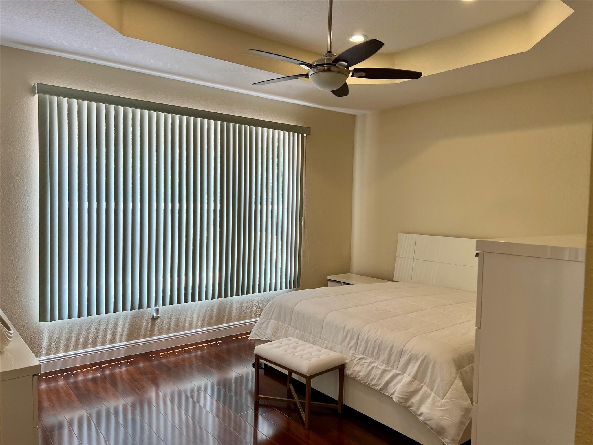 5201 Southwest 173rd Avenue Miramar, FL 33029 - Photo 11 of 42 a bedroom with a bed and a chandelier