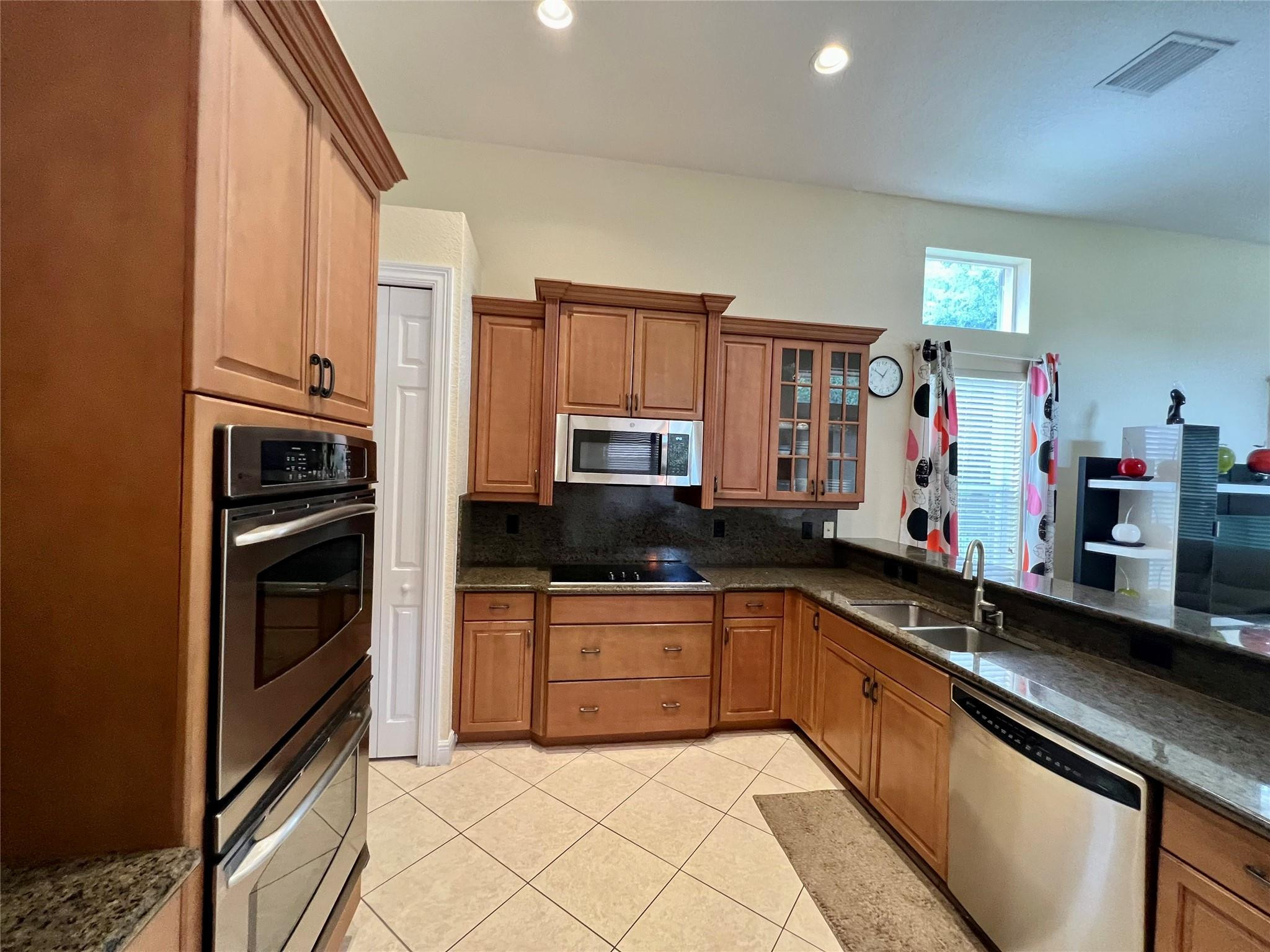 5201 Southwest 173rd Avenue Miramar, FL 33029 - Photo 24 of 42 a kitchen with stainless steel appliances a stove sink and cabinets