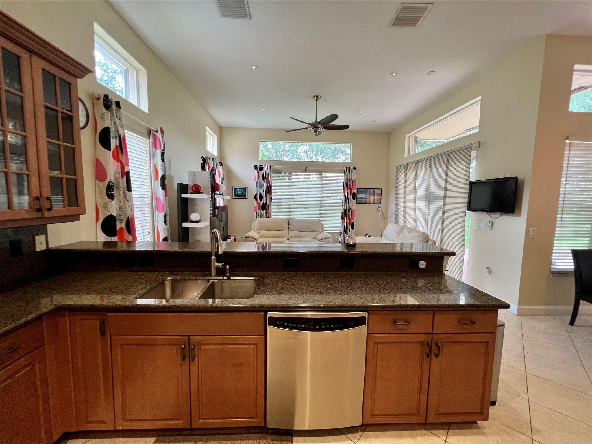 5201 Southwest 173rd Avenue Miramar, FL 33029 - Photo 27 of 42 a kitchen with stainless steel appliances granite countertop a sink and a microwave