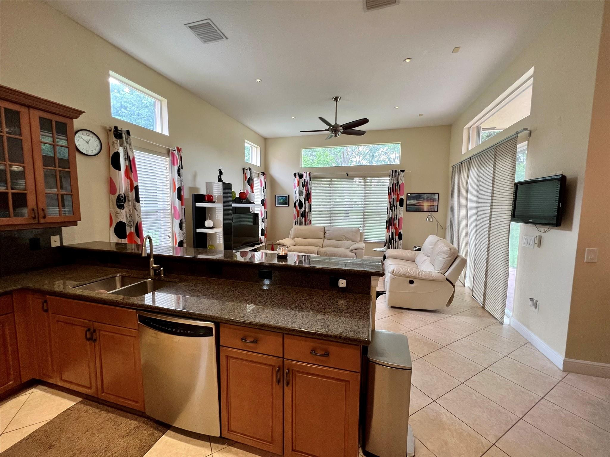 5201 Southwest 173rd Avenue Miramar, FL 33029 - Photo 28 of 42 a kitchen with stainless steel appliances granite countertop a sink refrigerator and cabinets