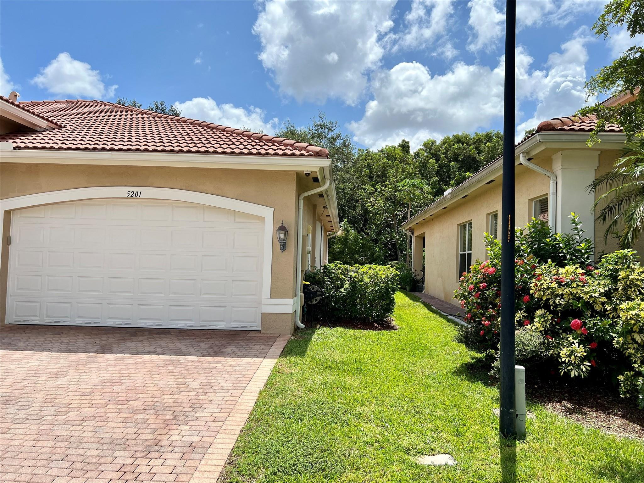 5201 Southwest 173rd Avenue Miramar, FL 33029 - Photo 3 of 42 a front view of a house with a yard and garage