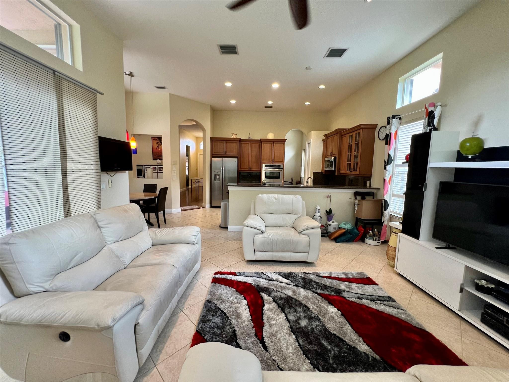 5201 Southwest 173rd Avenue Miramar, FL 33029 - Photo 31 of 42 a living room with furniture and a flat screen tv