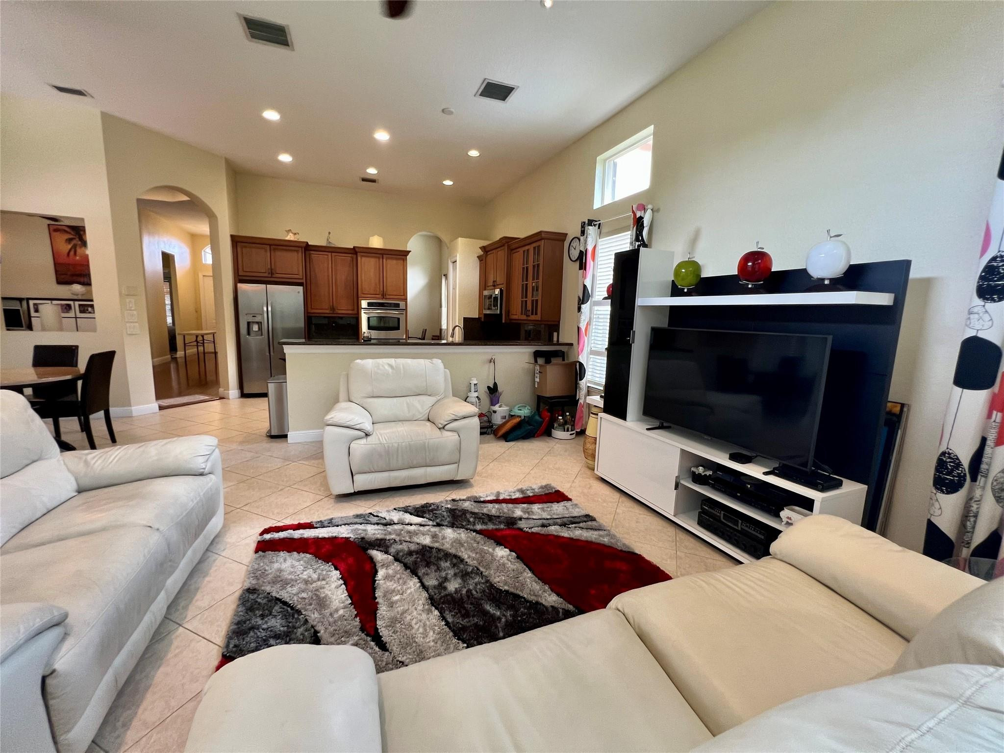 5201 Southwest 173rd Avenue Miramar, FL 33029 - Photo 32 of 42 a living room with furniture and a flat screen tv