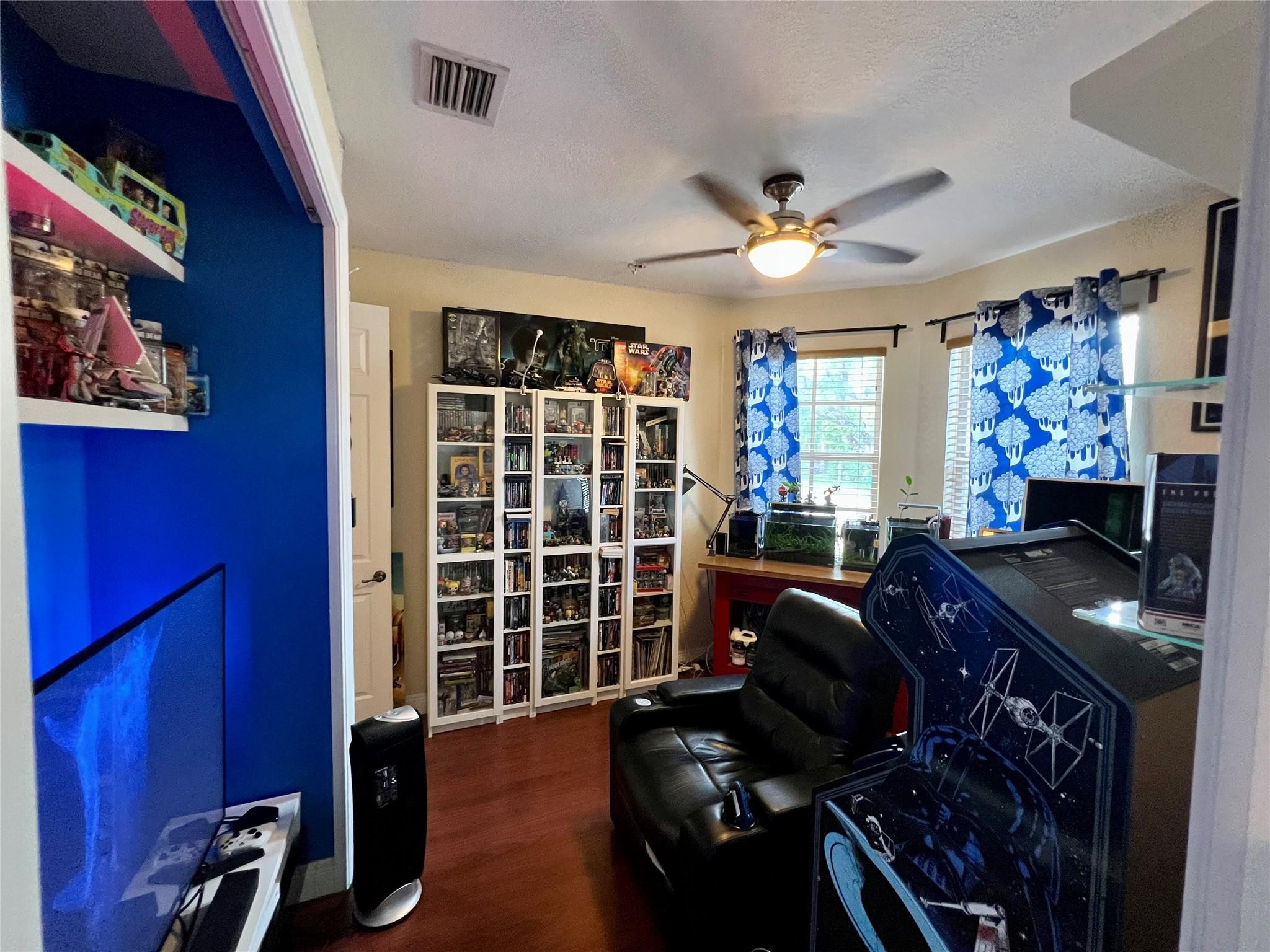 5201 Southwest 173rd Avenue Miramar, FL 33029 - Photo 37 of 42 a living room with furniture a bookshelf and a window