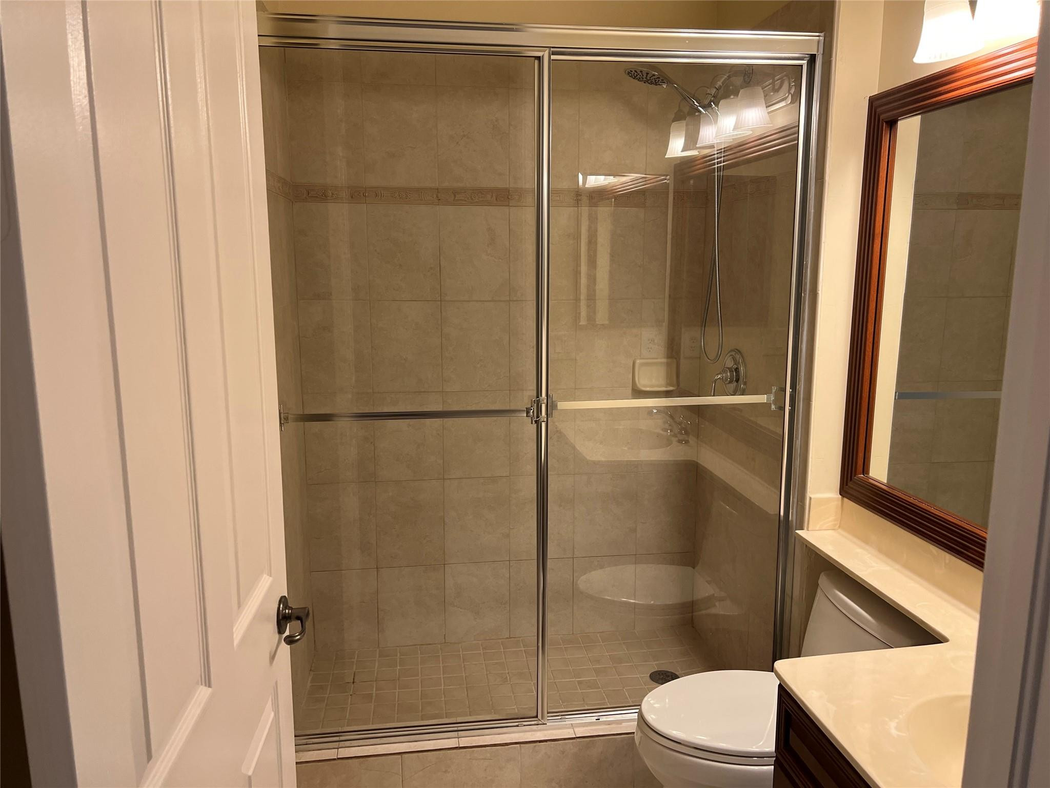 5201 Southwest 173rd Avenue Miramar, FL 33029 - Photo 5 of 42 a bathroom with a glass shower door