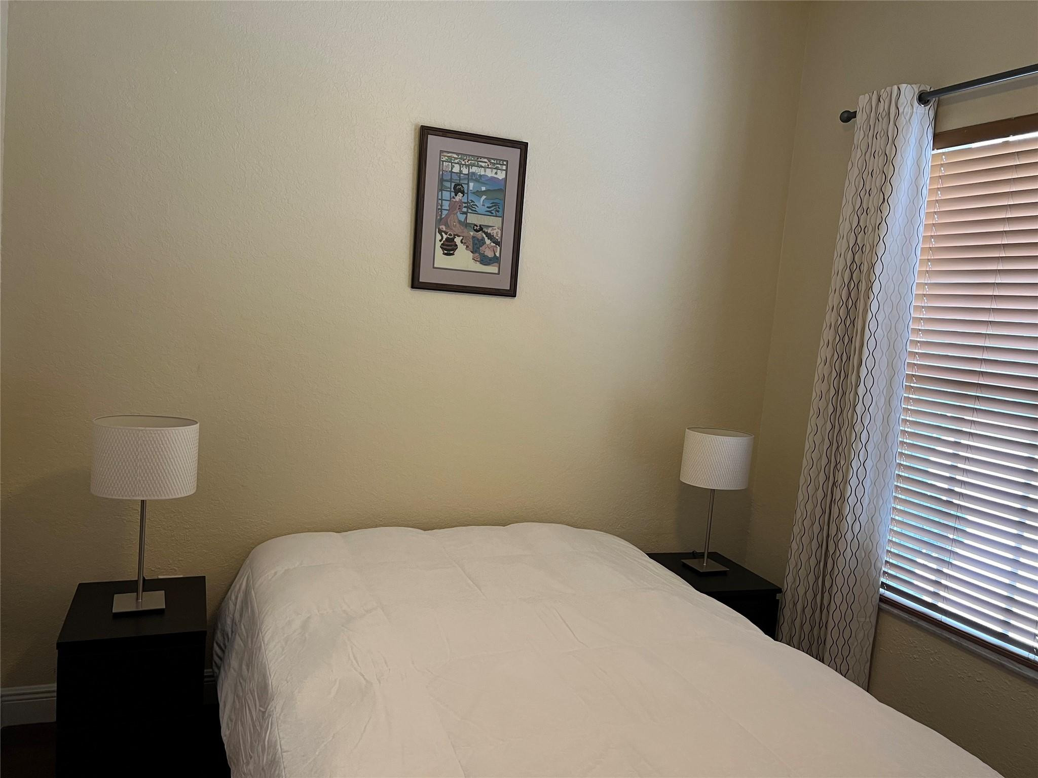 5201 Southwest 173rd Avenue Miramar, FL 33029 - Photo 6 of 42 a bedroom with a bed and a lamp on table