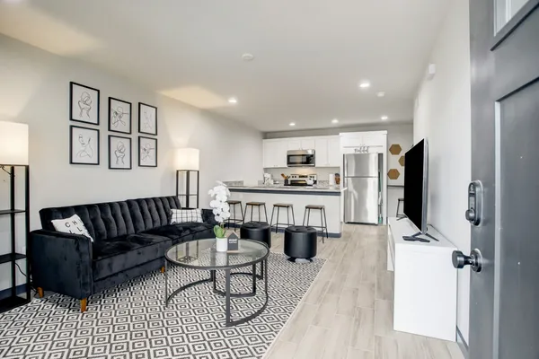 a living room with furniture and a flat screen tv