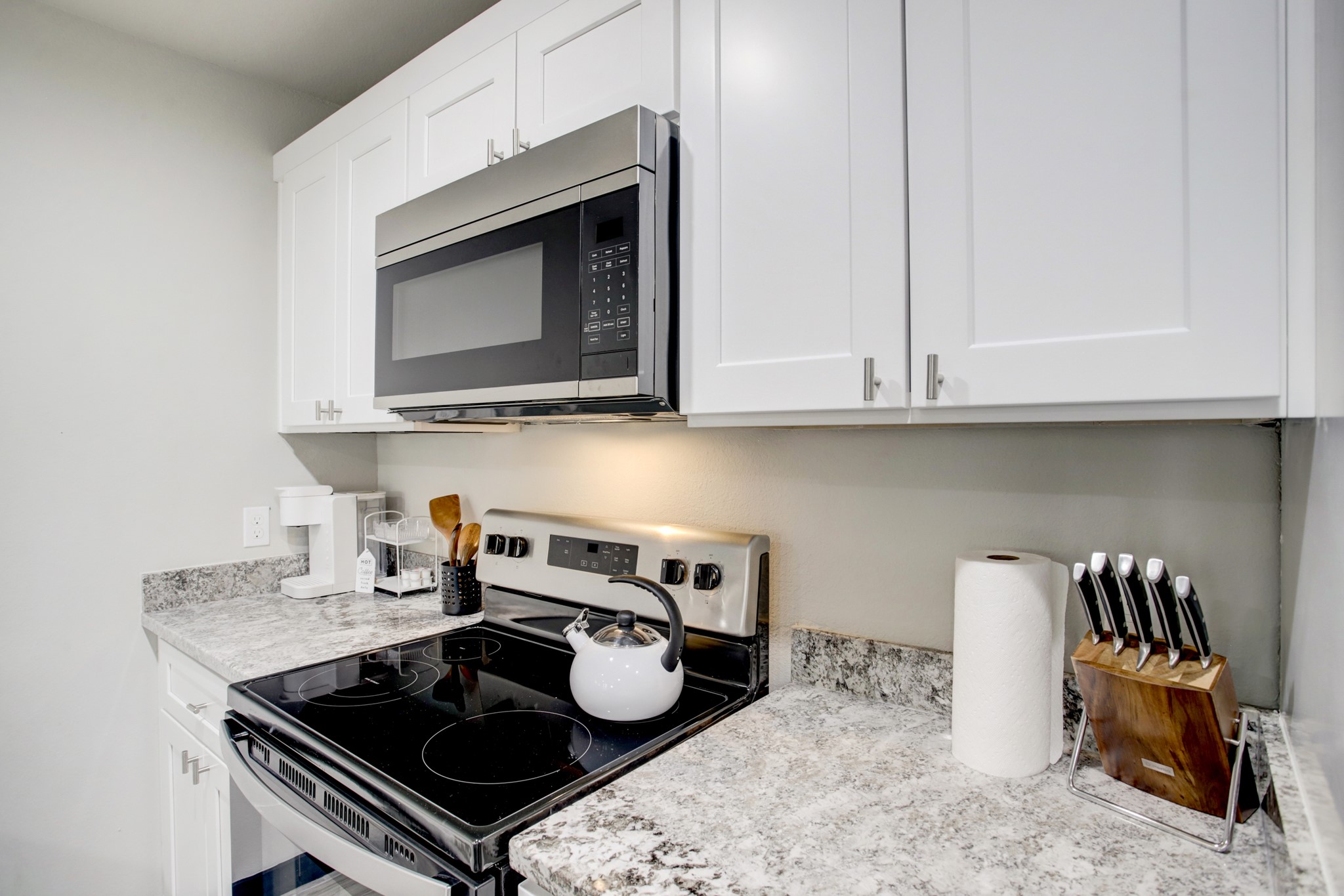 3448 Elgin Street, Unit 5 Houston, TX 77004 - Photo 2 of 8 a kitchen with a stove a microwave and cabinets