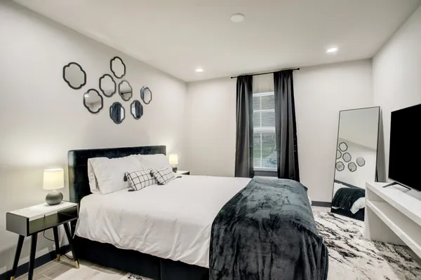 a bedroom with a bed and a flat screen tv