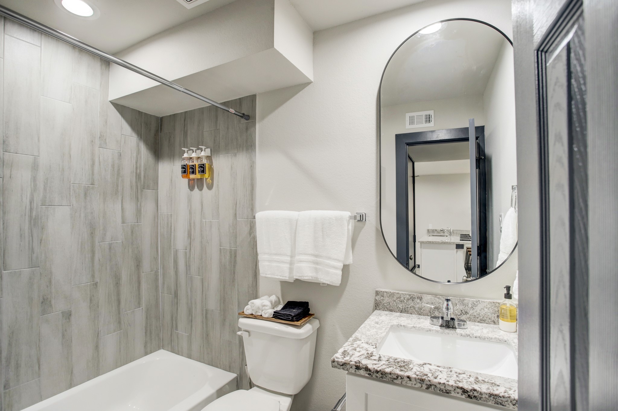 3448 Elgin Street, Unit 5 Houston, TX 77004 - Photo 5 of 8 a bathroom with a granite countertop sink mirror vanity and toilet