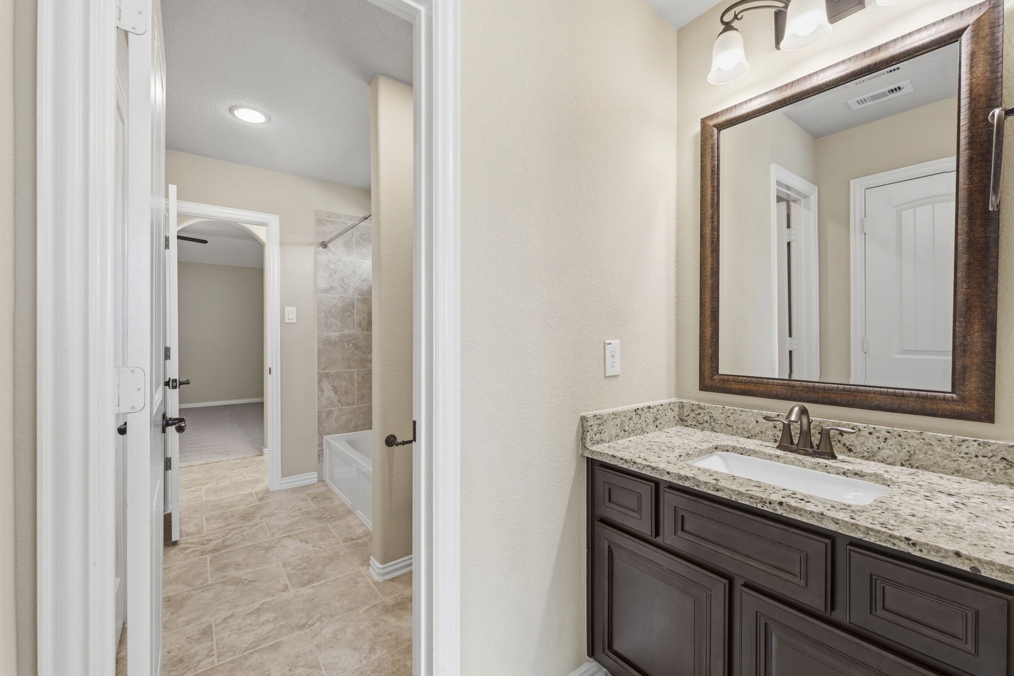 25210 Gaddis Oaks Drive Spring, TX 77389 - Photo 34 of 50 a bathroom with a granite countertop sink mirror and a