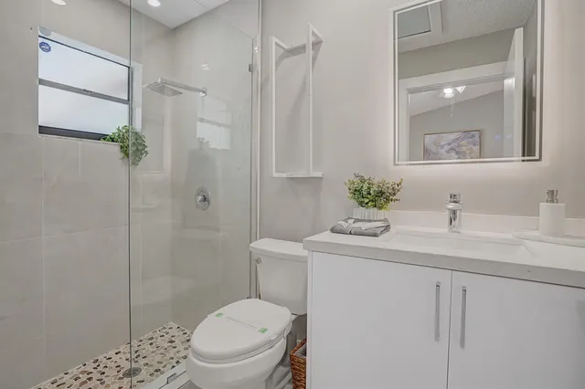 a bathroom with a sink toilet and shower