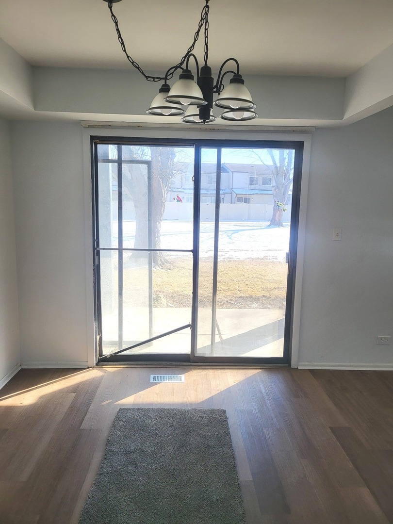 766 Mendocino Court, Unit 3 University Park, IL 60484 - Photo 4 of 5 an empty room with wooden floor and windows
