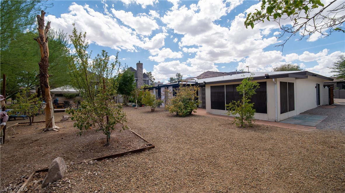 425 Blackridge Road Henderson, NV 89015 - Photo 22 of 31 Mature trees and low-maintenance desert landscaping surround this single-story home with a generous backyard area.