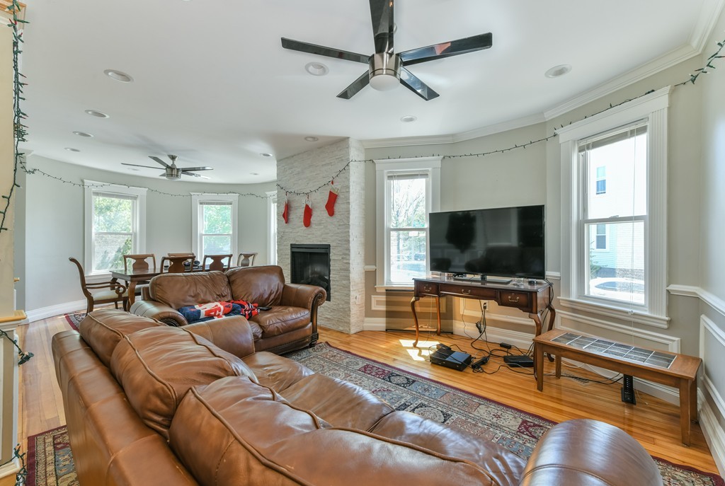 17-19 Pleasant Street Boston, MA 02125 - Photo 11 of 16 a living room with furniture and a flat screen tv