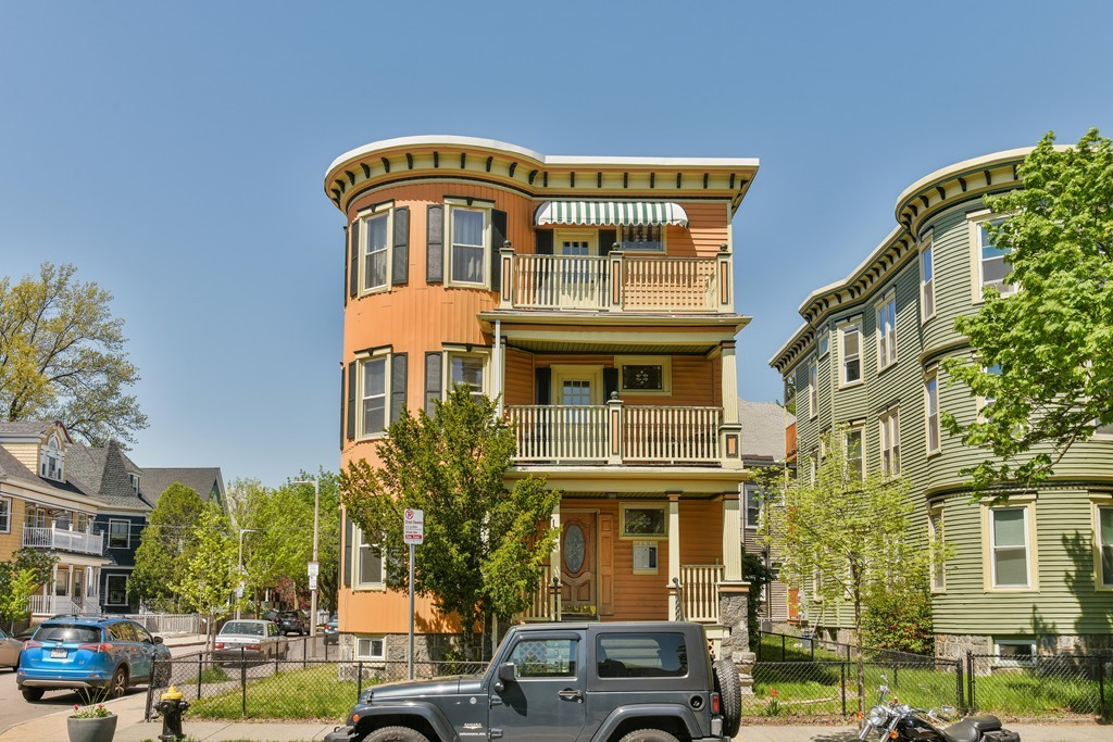 17-19 Pleasant Street Boston, MA 02125 - Photo 14 of 16 a front view of a residential apartment building with a yard
