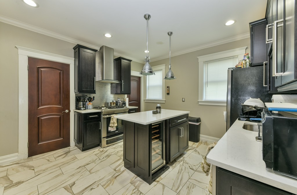 17-19 Pleasant Street Boston, MA 02125 - Photo 10 of 16 a kitchen with stainless steel appliances granite countertop a sink stove and refrigerator
