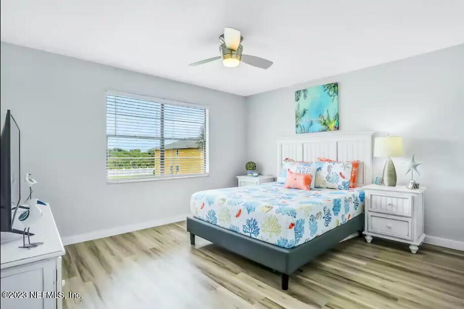 11 Clipper Court St. Augustine, FL 32080 - Photo 14 of 23 a bedroom with a bed and a chandelier