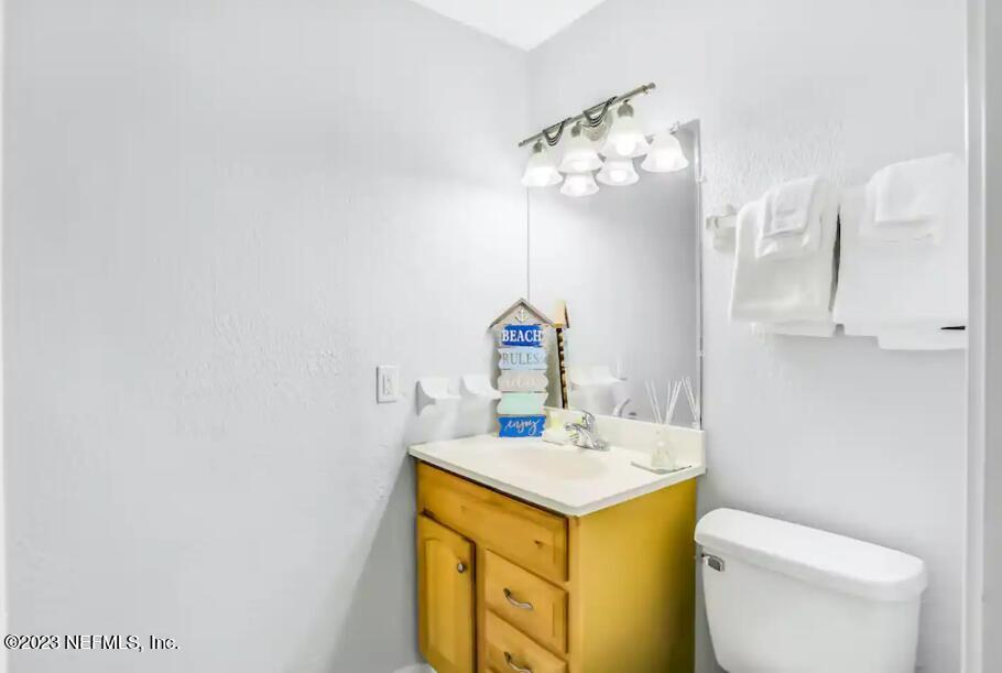 11 Clipper Court St. Augustine, FL 32080 - Photo 19 of 23 a bathroom with a sink vanity mirror and toilet