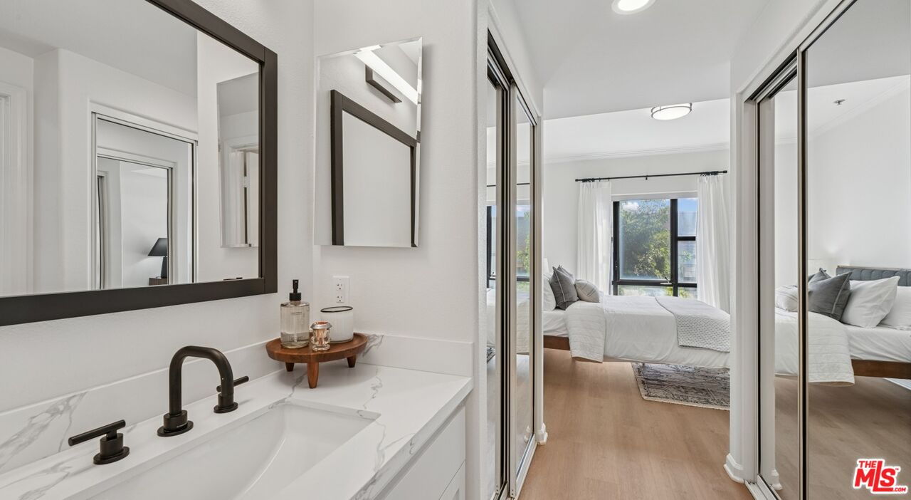 290 North Hudson Avenue, Unit 208W Pasadena, CA 91101 - Photo 19 of 21 a en suite bathroom with a double vanity sink and a large mirror
