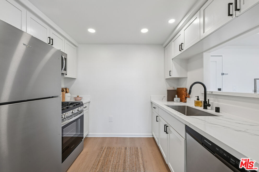 290 North Hudson Avenue, Unit 208W Pasadena, CA 91101 - Photo 21 of 21 a kitchen with stainless steel appliances a refrigerator sink and cabinets
