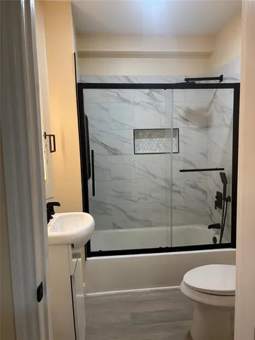 a bathroom with a shower and a toilet