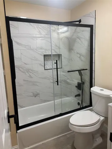 a bathroom with a shower and a toilet