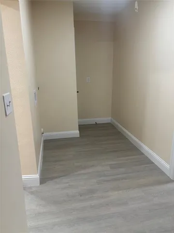 an empty room with wooden floor