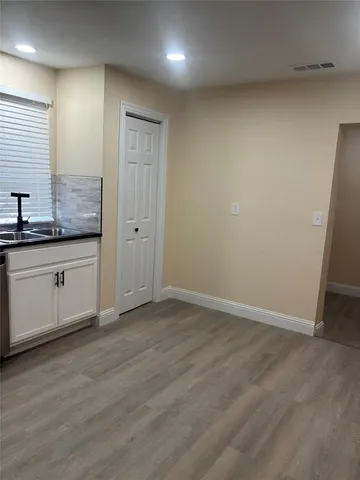 a view of a kitchen with granite countertop cabinets and wooden floor