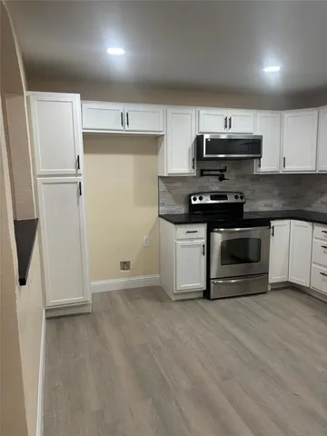 a kitchen with stainless steel appliances a stove a sink and a refrigerator
