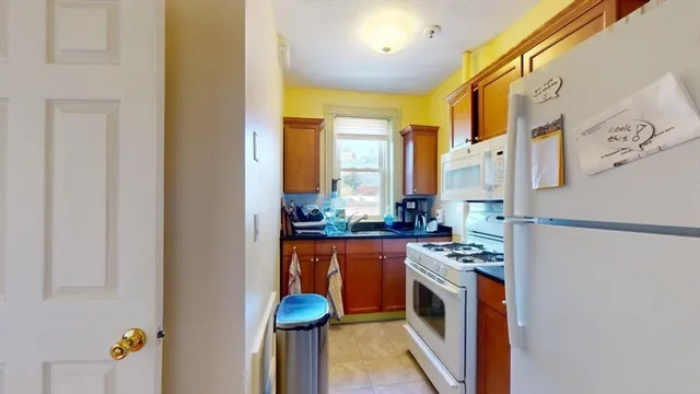 a kitchen with stainless steel appliances granite countertop a refrigerator and a stove