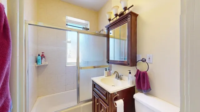 a bathroom with a sink vanity mirror and tub