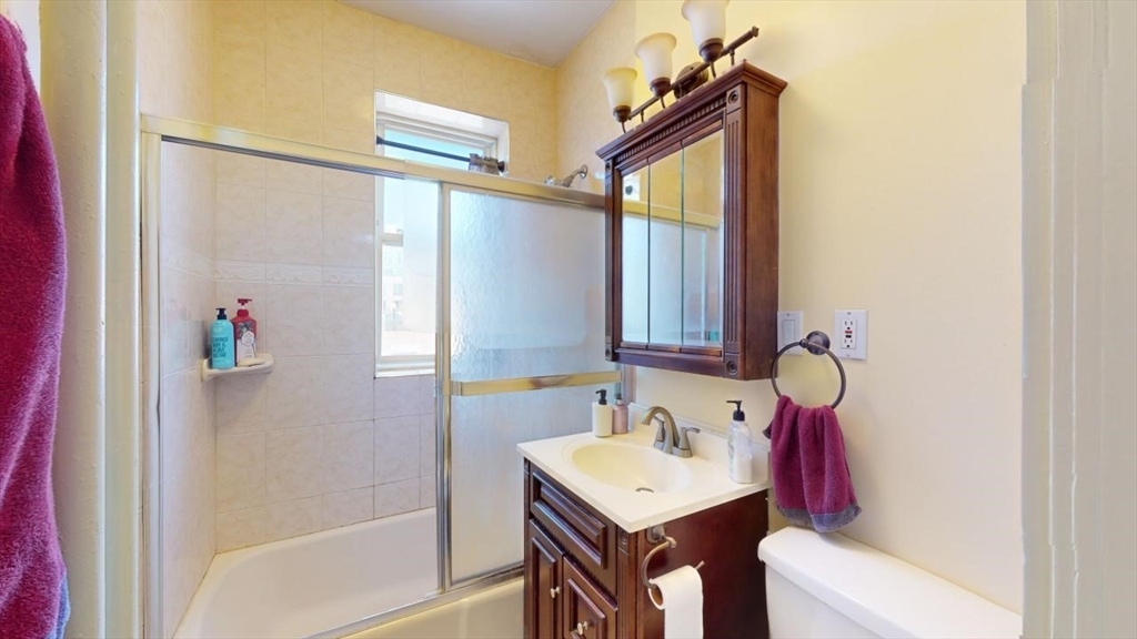 131 Park Drive, Unit 31 Boston, MA 02215 - Photo 9 of 15 a bathroom with a sink vanity mirror and tub