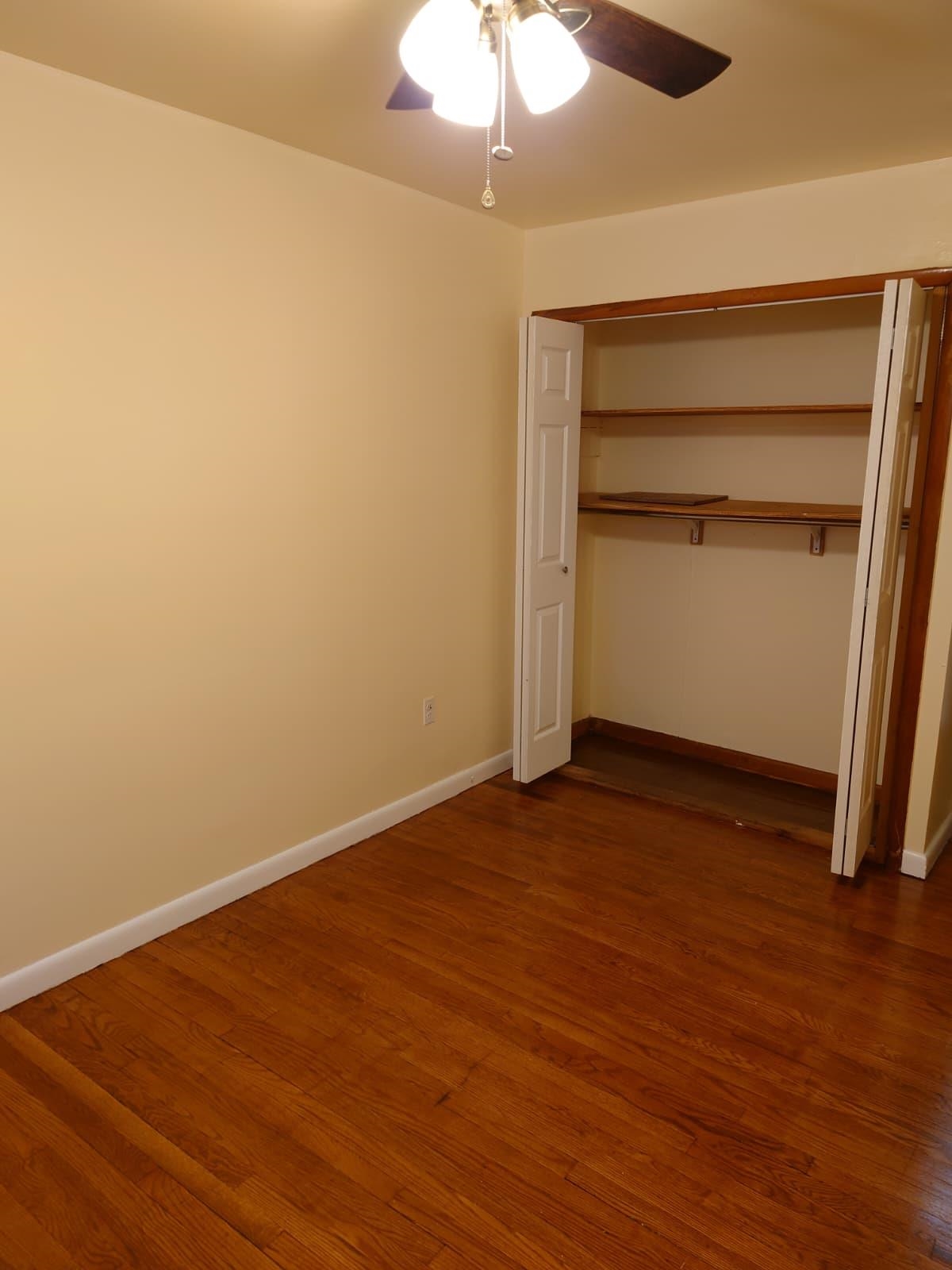 6129 Jackson Street, Unit 1 West New York, NJ 07093 - Photo 6 of 10 a view of an empty room with wooden floor and a window
