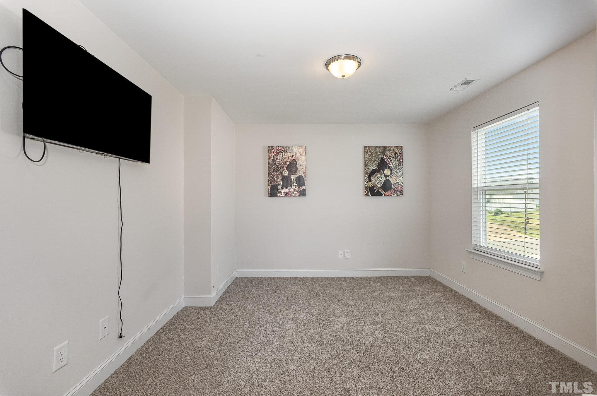 1513 Slate Ridge Road Knightdale, NC 27545 - Photo 18 of 36 a view of room with window and a flat screen tv