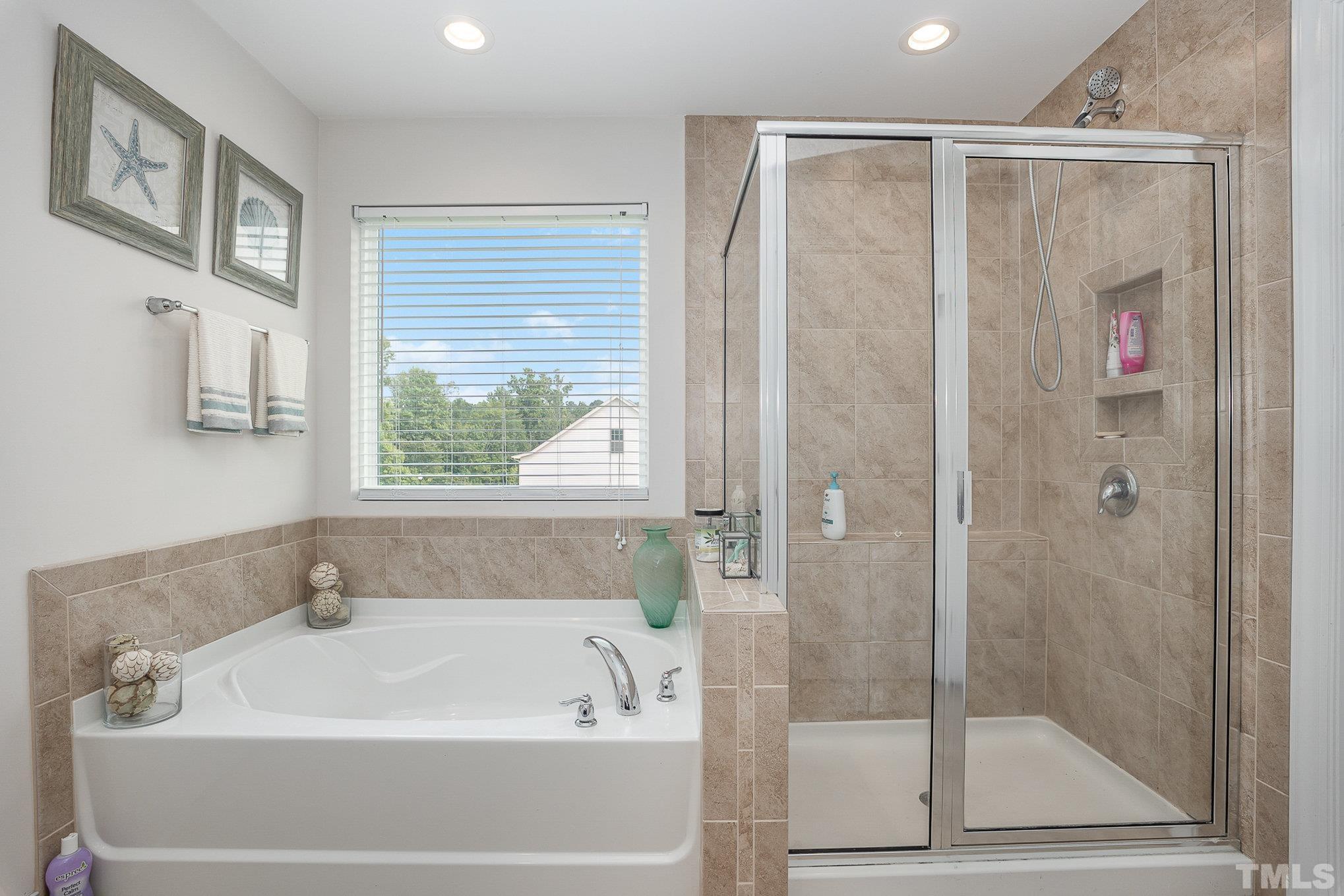 1513 Slate Ridge Road Knightdale, NC 27545 - Photo 20 of 36 a white bath tub sitting next to a shower