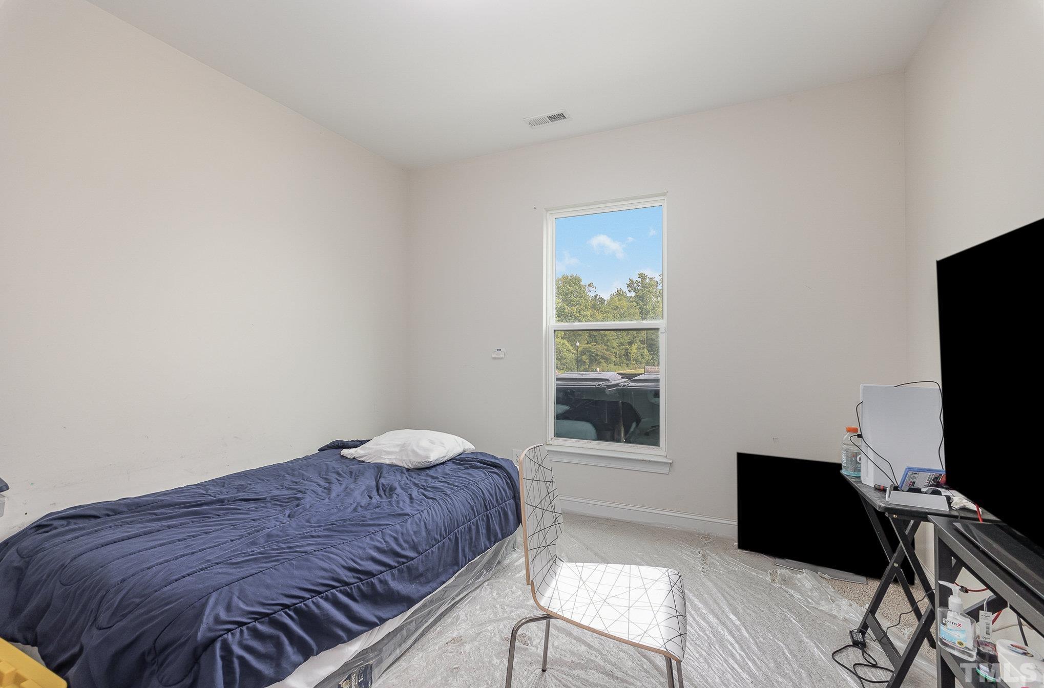 1513 Slate Ridge Road Knightdale, NC 27545 - Photo 21 of 36 a bedroom with a bed and a window