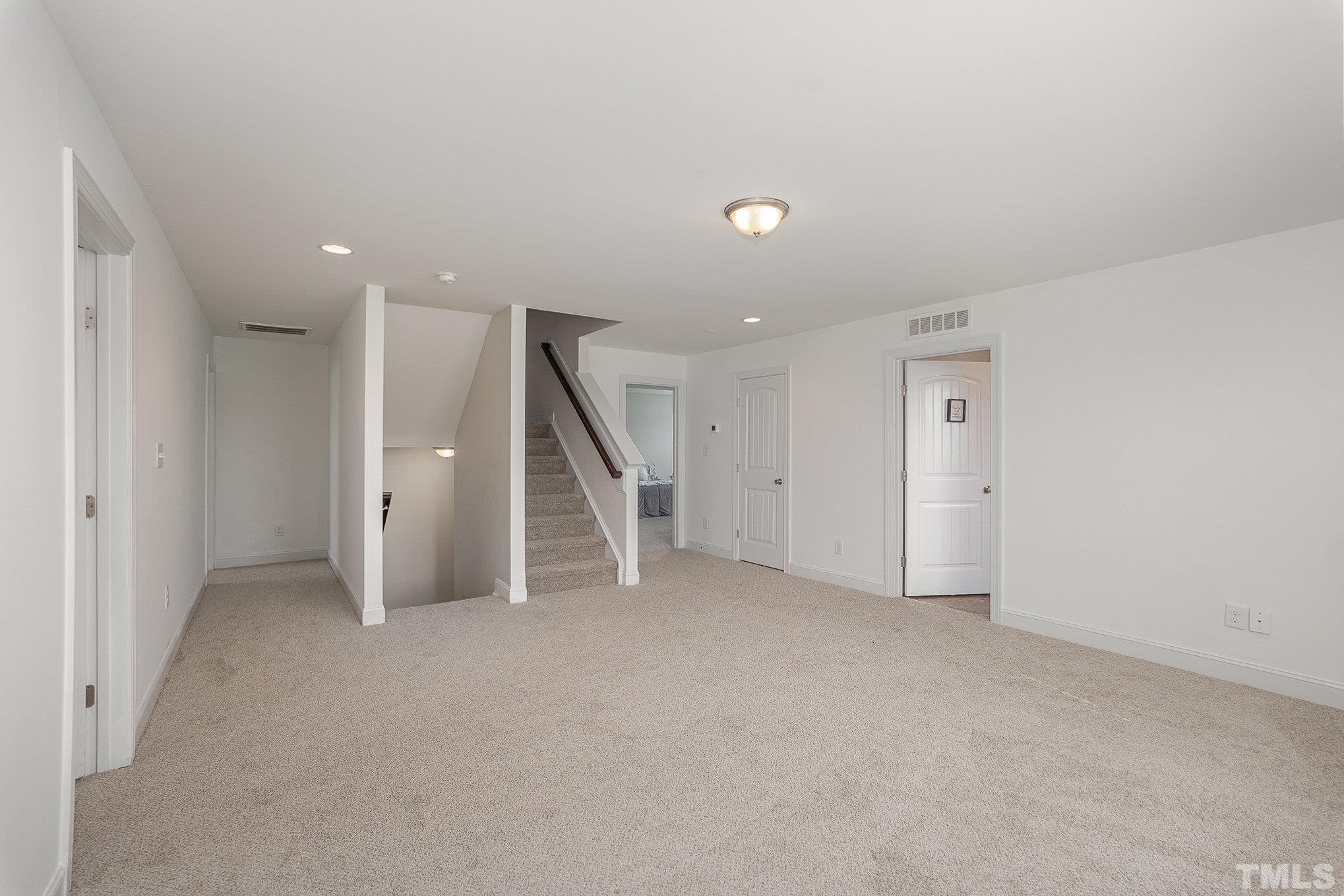 1513 Slate Ridge Road Knightdale, NC 27545 - Photo 23 of 36 an empty room with a ceiling fan