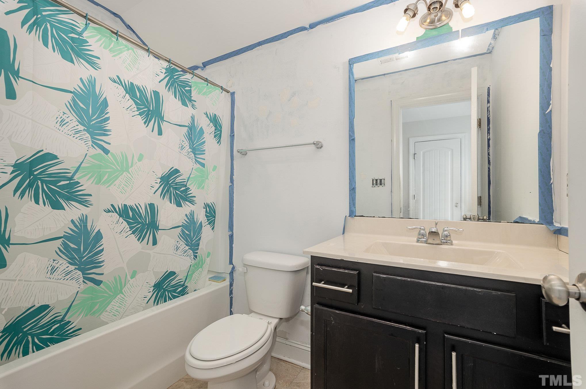 1513 Slate Ridge Road Knightdale, NC 27545 - Photo 29 of 36 a bathroom with a sink a toilet and shower curtain
