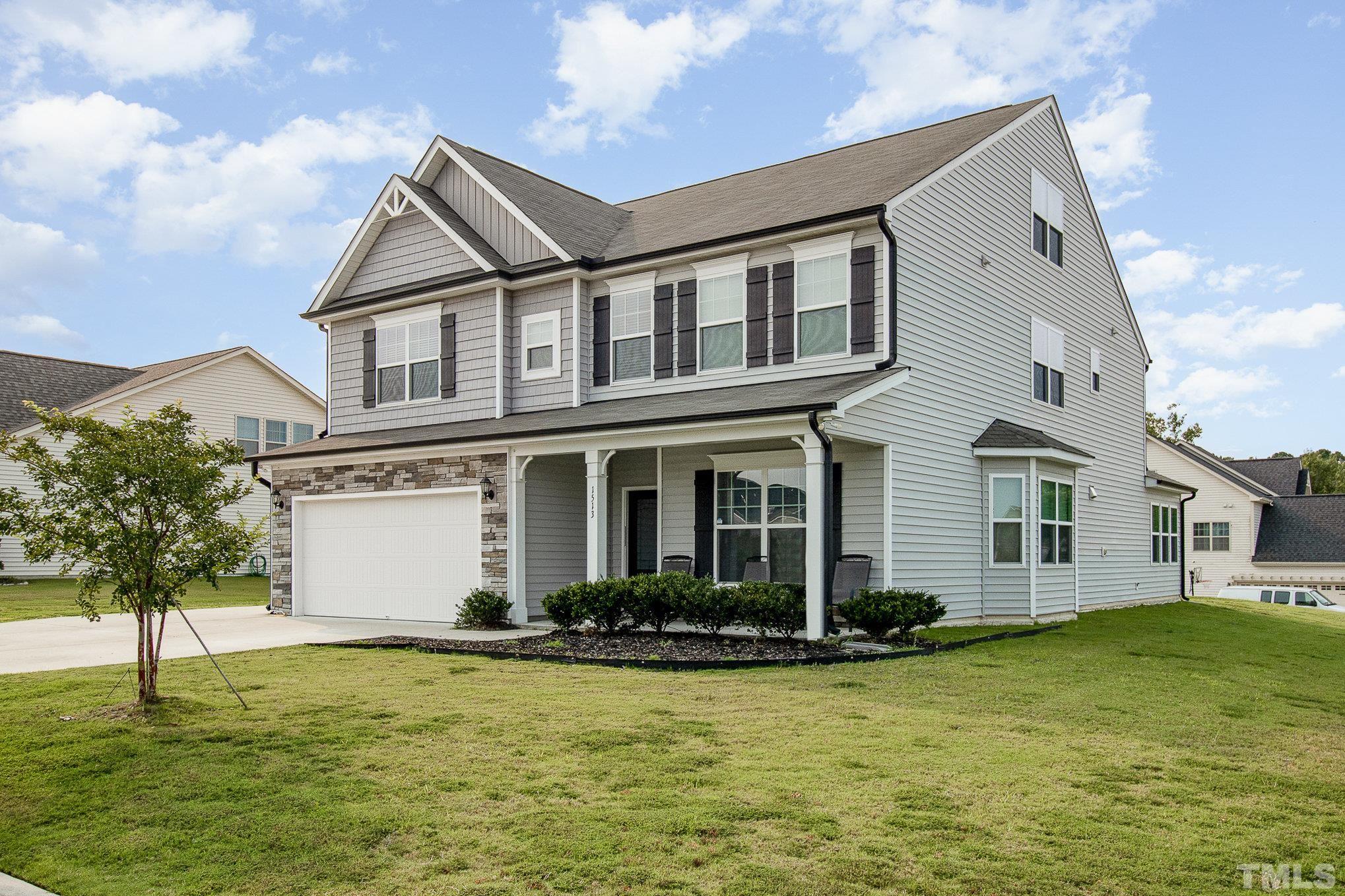 1513 Slate Ridge Road Knightdale, NC 27545 - Photo 3 of 36 a front view of a house with a yard