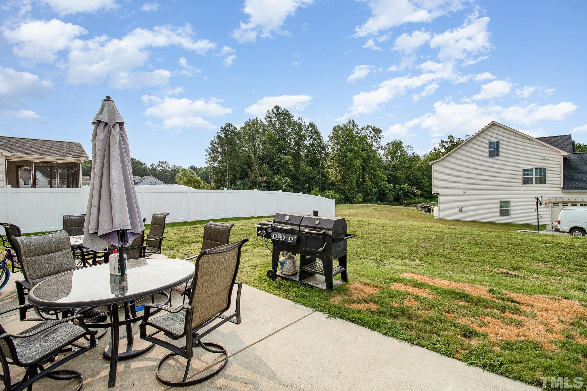 1513 Slate Ridge Road Knightdale, NC 27545 - Photo 31 of 36 a view of a patio with table and chairs and potted plants