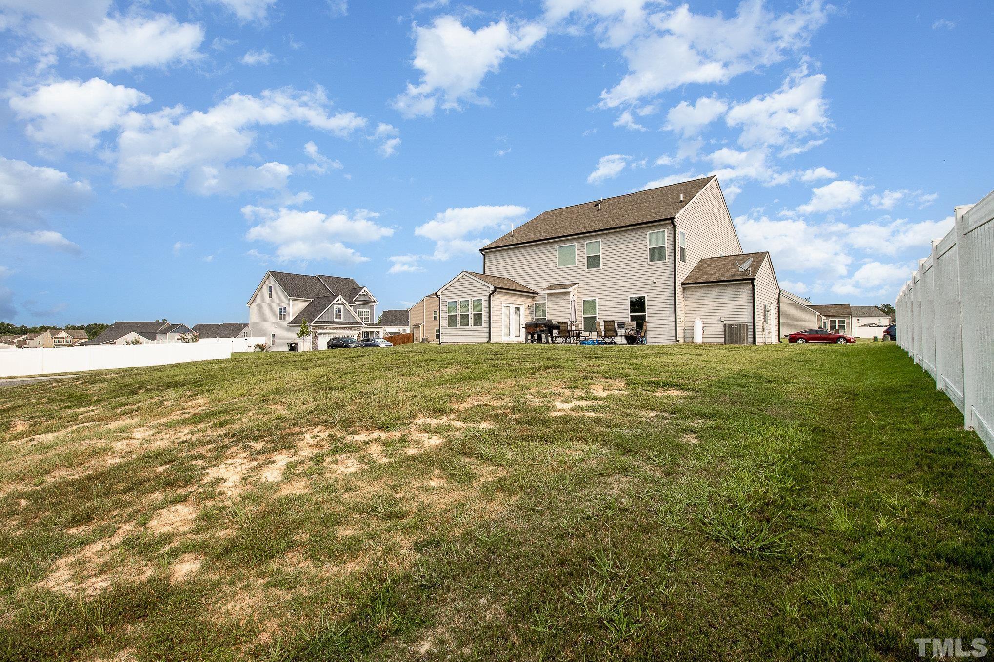 1513 Slate Ridge Road Knightdale, NC 27545 - Photo 33 of 36 a large white house with a large pool