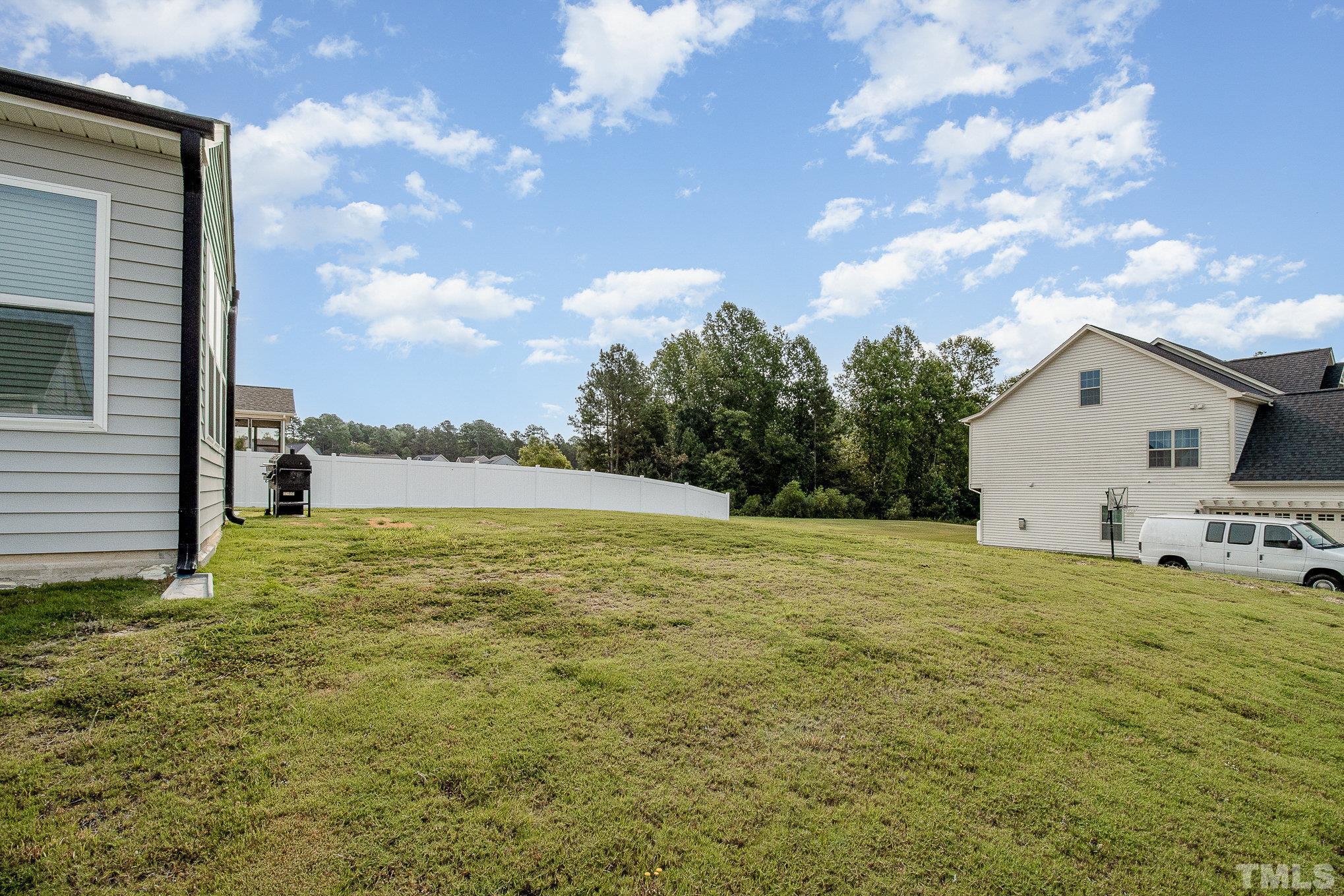 1513 Slate Ridge Road Knightdale, NC 27545 - Photo 35 of 36 a house view with swimming pool and trees in the background
