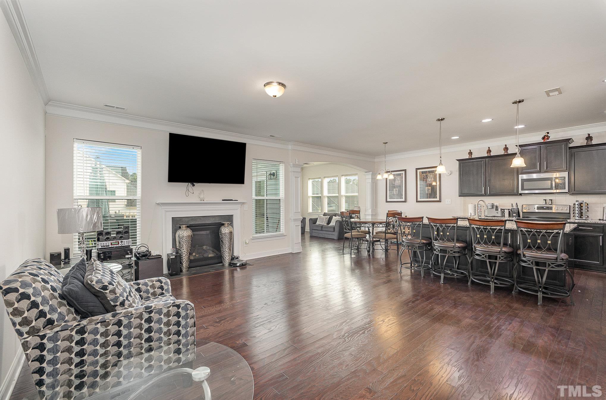 1513 Slate Ridge Road Knightdale, NC 27545 - Photo 7 of 36 a living room with furniture kitchen view and a fireplace