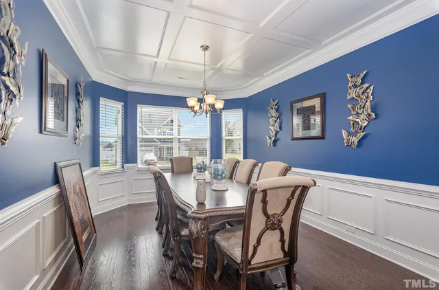 a view of a dining room with furniture large window and wooden floor