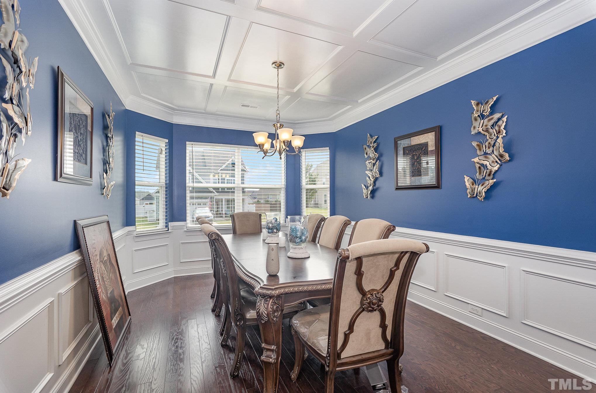 1513 Slate Ridge Road Knightdale, NC 27545 - Photo 9 of 36 a view of a dining room with furniture large window and wooden floor